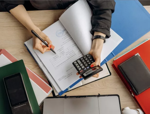 table-feuilles-mains-avec-stylo-et-calculatrice-IHECF-Lyon